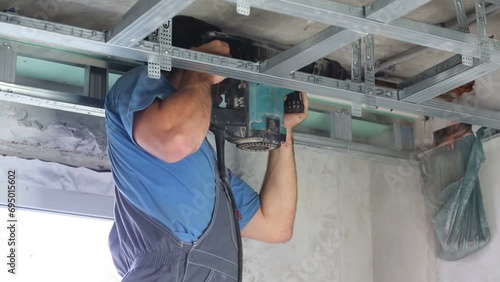 Man makes holes for construction for air conditioner photo