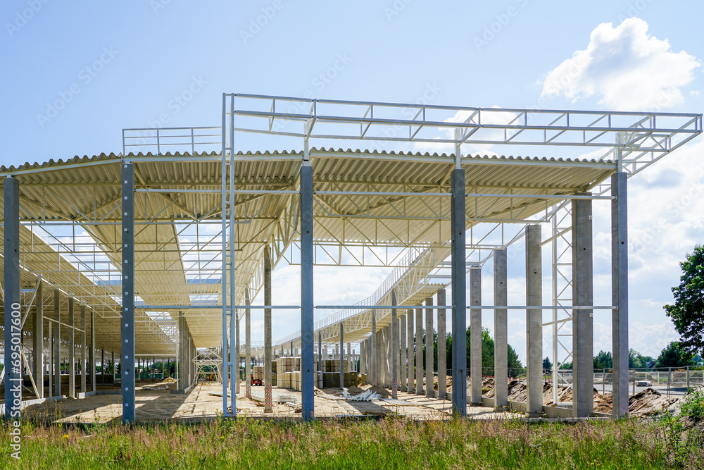 New large building steel framework with corrugated steel roof on reinforced concrete supports New large building steel framework with corrugated steel roof on reinforced concrete supports
