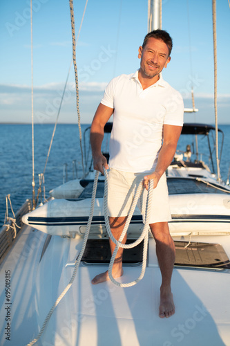 Contented and determined mature man on a yacht