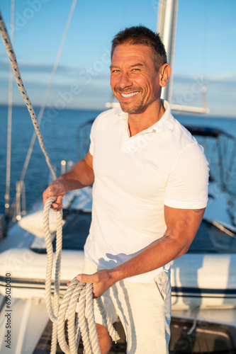 Contented and determined mature man on a yacht
