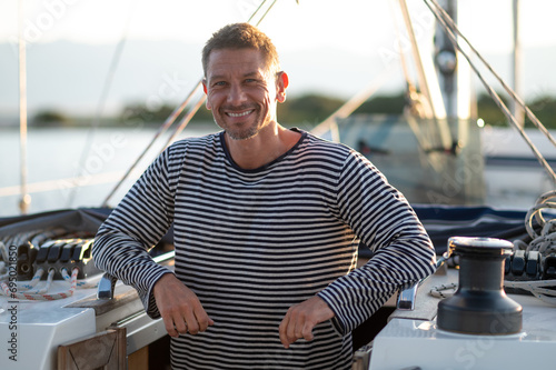 Smiling man in a striped thsirt on ayacht