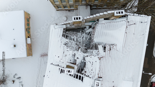 Drone photography of a building with broken rooftop during winter