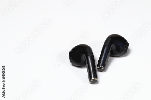 Black Wireless bluetooth earphone or earbud or headphone, isolated on white background.