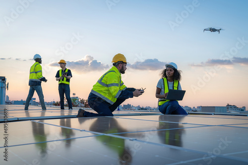Engineer working setup Solar panel at the roof top. Engineer or worker work on solar panels or solar cells on the roof of business building photo