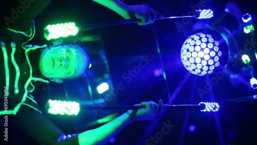 Bottom view of man in samurai garb performing with glow sticks