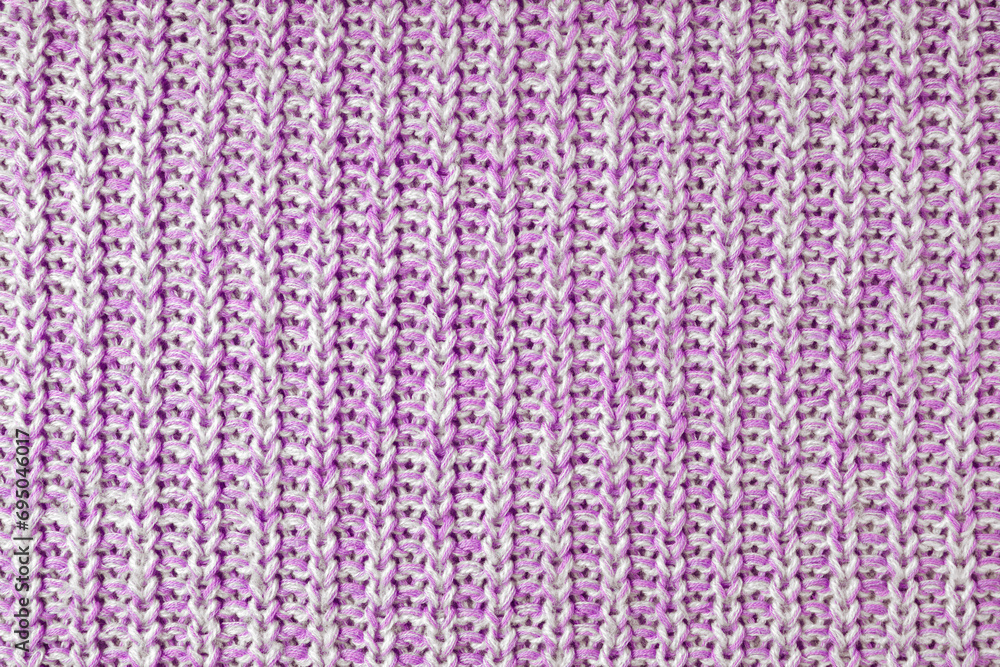 Jersey textile background , pink white melange knitted wool fabric. Woolen knitwear, sweater, pullover surface texture, textile structure, cloth surface, weaving of knitwear material