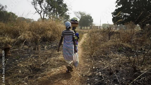 Two girls in traditional African robes walk along the landing photo