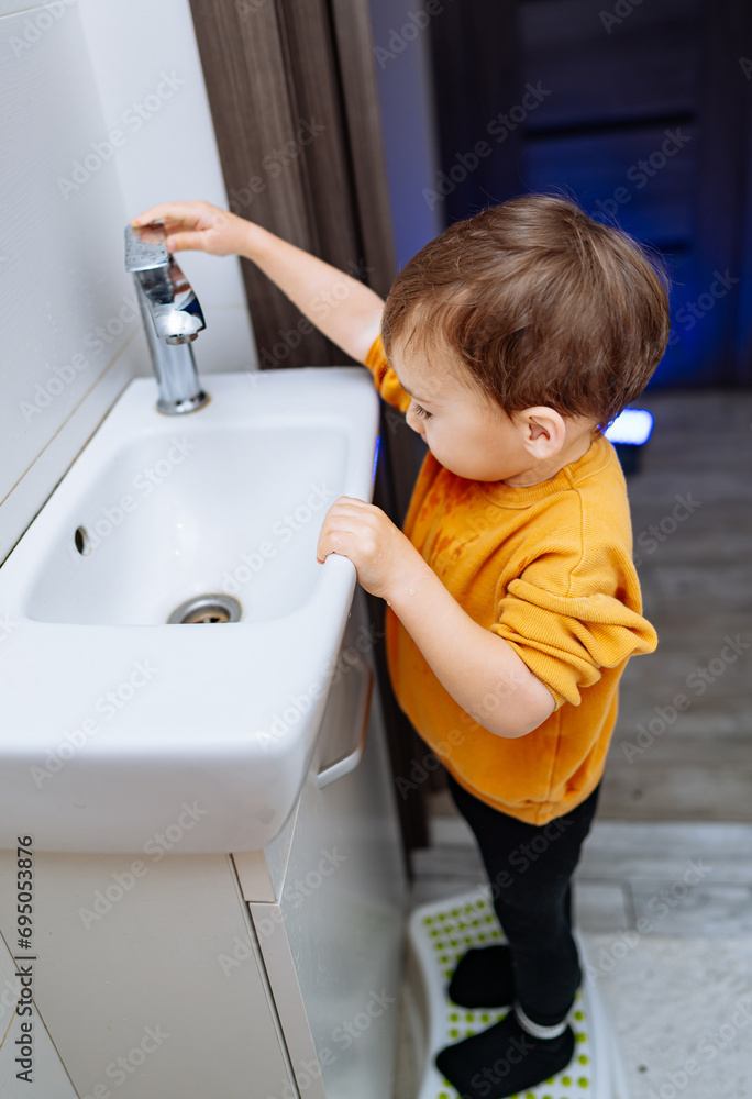 Kid cleaning with soap hands. Boy learning washing hands. Kid cleaning with soap hands. Boy learning washing hands.
