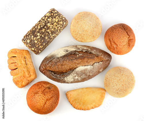 Beautiful baked bread and buns isolated on white. Top view.