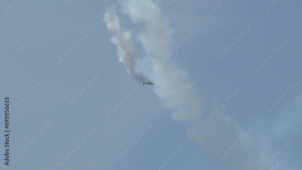 Aircraft flying performing stunts in airshow Aircraft flying performing stunts in airshow