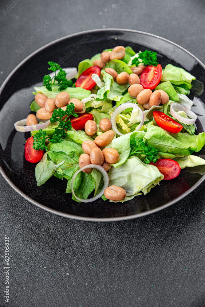 white bean salad green lettuce, tomato healthy eating cooking appetizer meal food snack on the table copy space food background rustic top view 