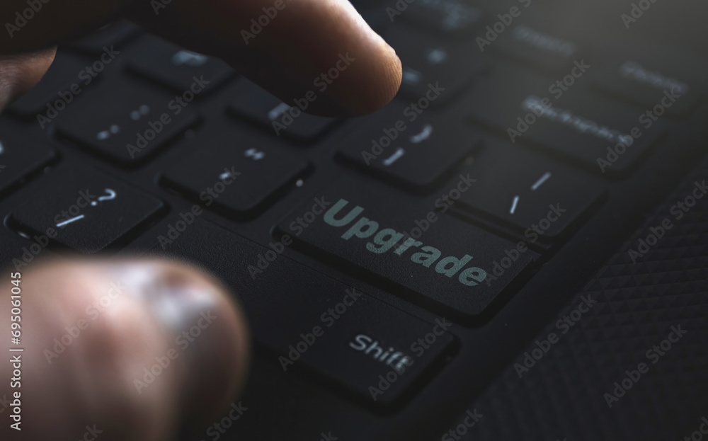 Close-up of a hand confidently selecting the 'Upgrade' option. Illustrating the concept of seamless advancements for an enhanced user experience Close-up of a hand confidently selecting the 'Upgrade' option. Illustrating the concept of seamless advancements for an enhanced user experience