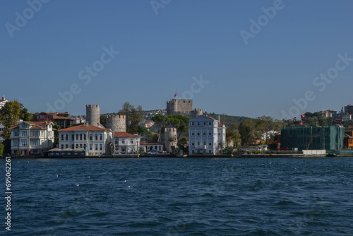Anadoluhisar Fortress in Asia Minor, built for Ottoman siege of Constantinople, sits on opposite banks of Bosphorus from Rumeli Hisari Fortress surrounded by residences and  apartments.
