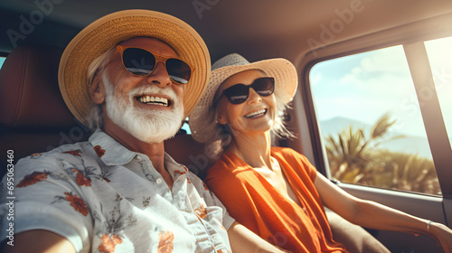 Happy elderly couple in car travel. Adventure travel, active holiday. Banner