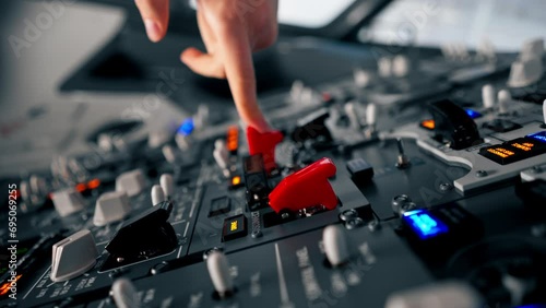 close-up hand of the pilot captain presses the buttons on the control panel to start the engine of the plane Flight simulator close-up