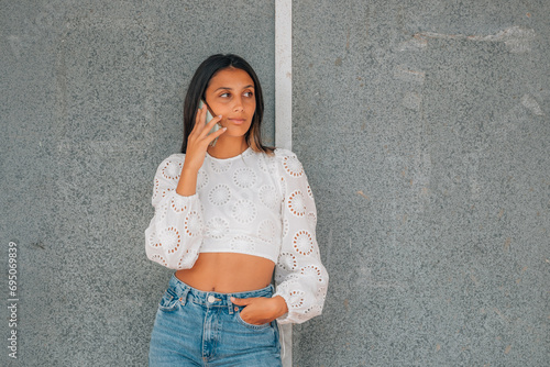 hispanic latina girl talking on mobile phone on the street