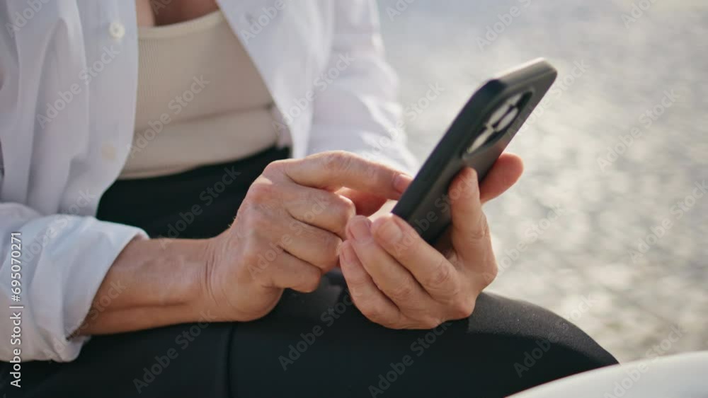 Mature hands typing cellphone screen sitting street closeup. Aged lady messaging Mature hands typing cellphone screen sitting street closeup. Aged lady messaging