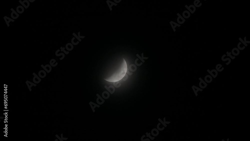 Tokyo, Japan - December 18, 2023: A half-moon covered with faint clouds in Japan
 photo