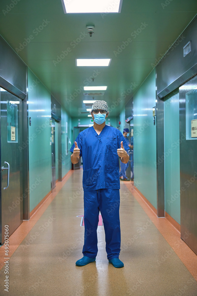 surgeon walks down a long corridor surgeon walks down a long corridor