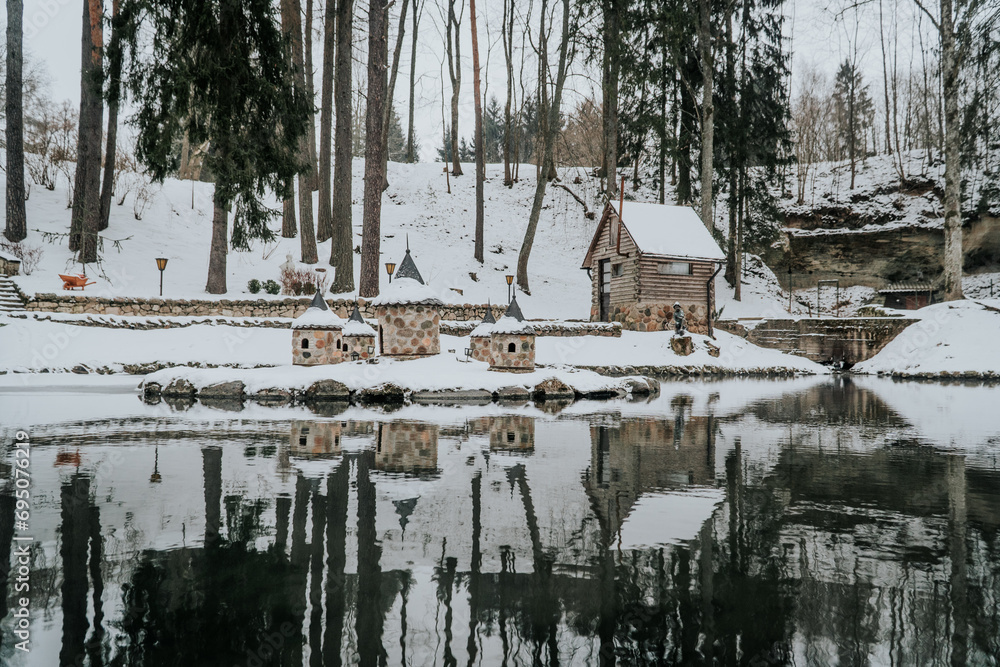 Tranquil Winter Forest: Solitude in a Cold Day with Mirror Image Reflection on Ice Lake Tranquil Winter Forest: Solitude in a Cold Day with Mirror Image Reflection on Ice Lake