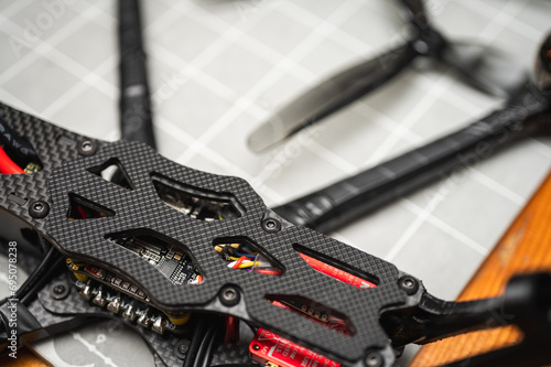 Frame, FPV racing drone frame, assembly, soldering, for the armed forces of Ukraine, installed with tools on the desktop, close-up view