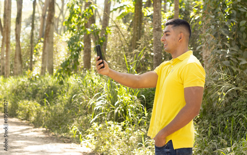 tall man in yellow t-shirt taking a photo