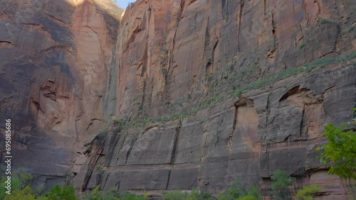 Establishing shot of mountains with red rocks in Temple of Sinawava, Zion National Park, Utah, North America. Day time. ProRes 422 HQ. photo