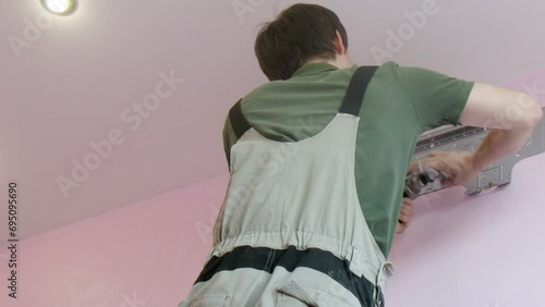 Worker begins to install the air conditioner. Time lapse. photo