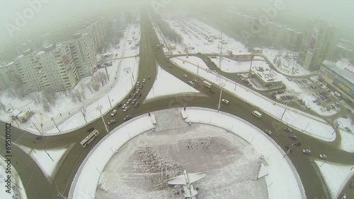 Traffic on round square with monument of attack-plane IL-2 photo