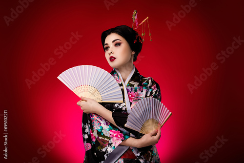 Photo of elegant lady dressed japanese dress kimono looking empty space isolated on red gradient color background