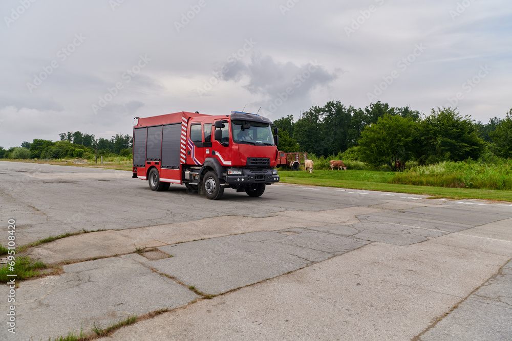 In this captivating scene, a state-of-the-art firetruck, equipped with advanced rescue technology, stands ready with its skilled firefighting team, prepared to intervene and respond rapidly to