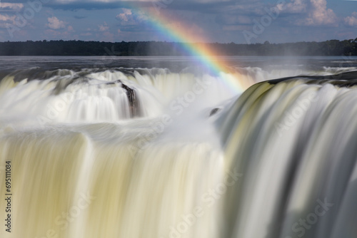Waterfall details with rainbow at Devil's Throat at Iguazu Waterfalls in Brazil photo