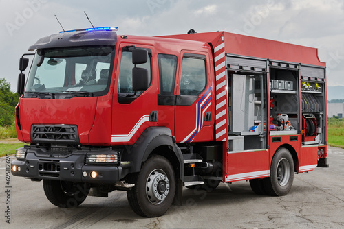 In this captivating scene  a state-of-the-art firetruck  equipped with advanced rescue technology  stands ready with its skilled firefighting team  prepared to intervene and respond rapidly to