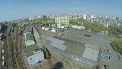 Storage with containers near railway in city at sunny day photo