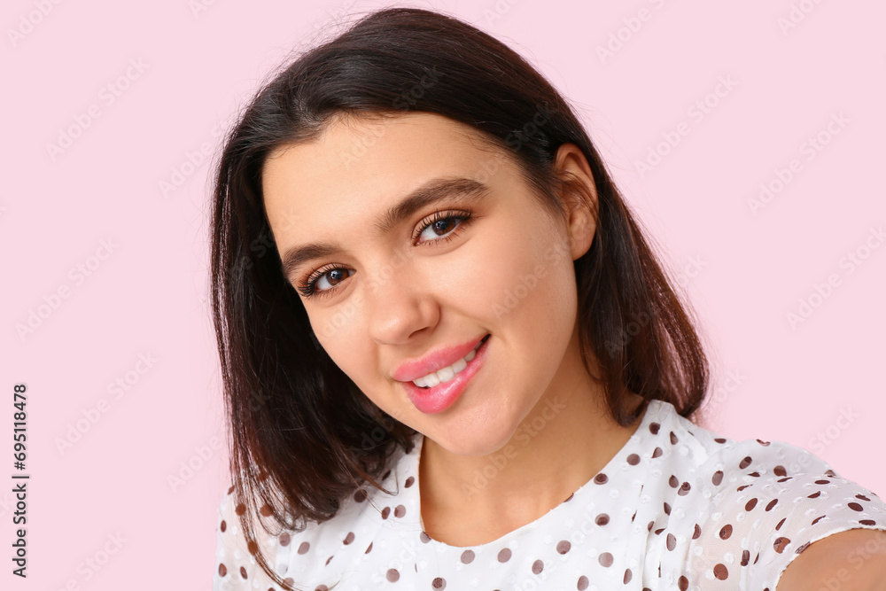 Young woman biting lip on pink background, closeup. Online dating concept Young woman biting lip on pink background, closeup. Online dating concept