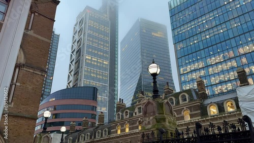 Fog surrounding the skyscrapers near Liverpool street railway station in London, England photo