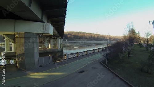 Plants on river quay and metro bridge at spring day. Aerial view photo