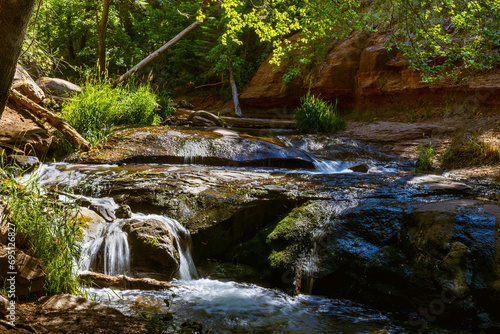 Water cascades over layers of mossy rock along the Tonto Creek in the Mogollon Rim country of Arizona.