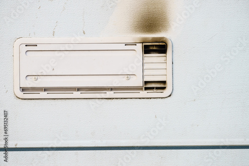 Camper car detail. Grid, ventilation plate for fridge with smoke photo