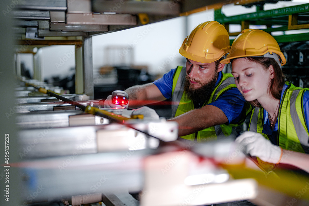 technician engineers team checking the machine and maintenance service. workers looking at spare parts in stock at warehouse factory. laborer with a checklist and laser scanning device on steel part.