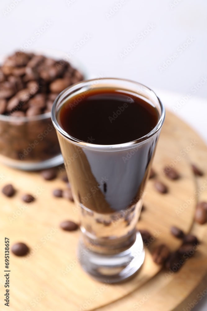 Shot glass of coffee liqueur on table, closeup Shot glass of coffee liqueur on table, closeup