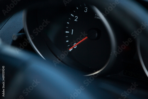 Close up of a speedometer on a car's dashboard. 