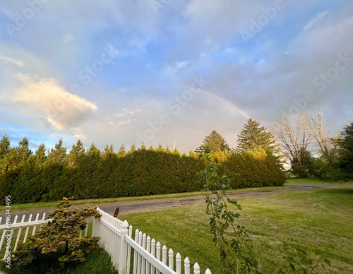 Rainbow white fence and blue sky
