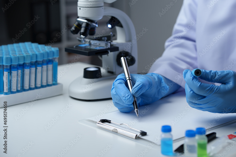Scientist wearing medical gloves nanotechnology, research, fiber, microbiology, glass, test tube, medicine, healthcare, pharmaceutical manufacturing, laboratory, science, chemistry, genetics, genes. Scientist wearing medical gloves nanotechnology, research, fiber, microbiology, glass, test tube, medicine, healthcare, pharmaceutical manufacturing, laboratory, science, chemistry, genetics, genes.