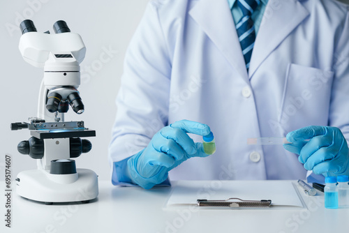 Scientist wearing medical gloves nanotechnology, research, fiber, microbiology, glass, test tube, medicine, healthcare, pharmaceutical manufacturing, laboratory, science, chemistry, genetics, genes.