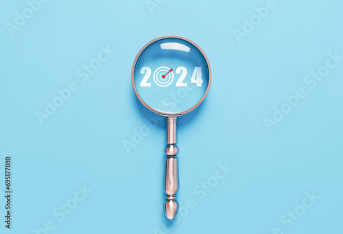 Wallpaper Mural magnifying glass shows the new year 2024. concept of action business plan targets, and growth. The Economic Analysis 2024, finance goal to success, Making a profit in the investment market Torontodigital.ca