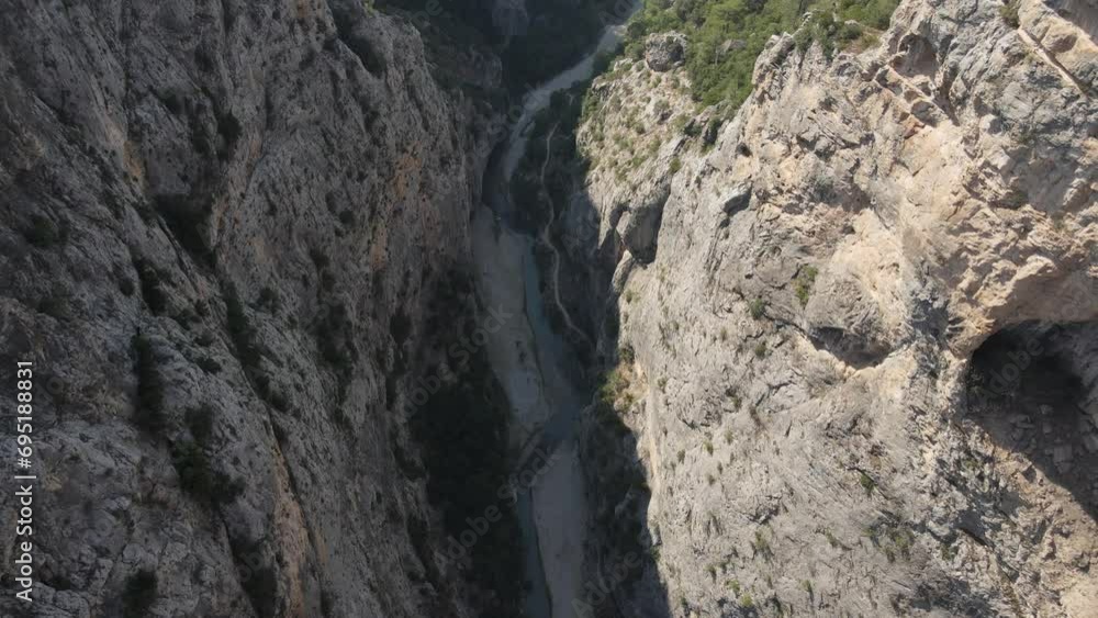 Drone view of the giant canyon formed between two large mountains, mountain tops with forest Drone view of the giant canyon formed between two large mountains, mountain tops with forest