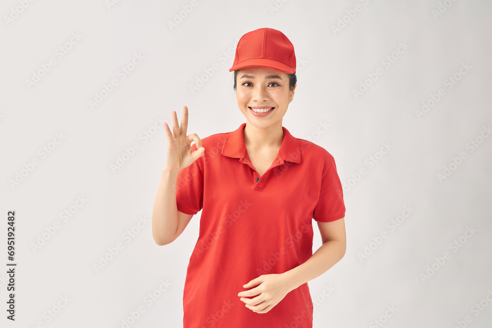 Delivery friendly woman in red uniform isolated on white background Delivery friendly woman in red uniform isolated on white background