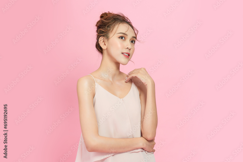 Beautiful young Asian woman on pink pastel background, summer vacation concept Beautiful young Asian woman on pink pastel background, summer vacation concept