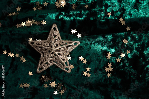 Abstract Christmas background with gold stars on a green velvet background. photo